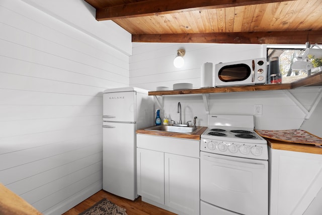 kitchen featuring white appliances, sink, hardwood / wood-style flooring, wooden ceiling, and white cabinetry