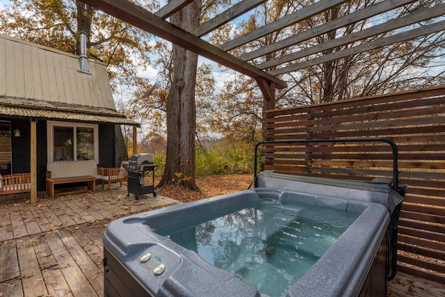 wooden deck with area for grilling, a pergola, and a hot tub