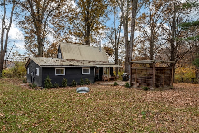 rear view of property featuring a lawn