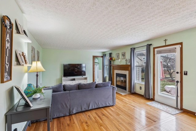 living room featuring a textured ceiling and light hardwood / wood-style flooring