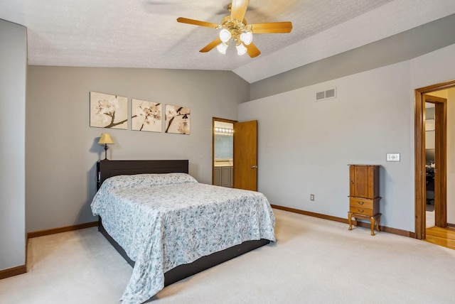 carpeted bedroom with ceiling fan, lofted ceiling, and a textured ceiling