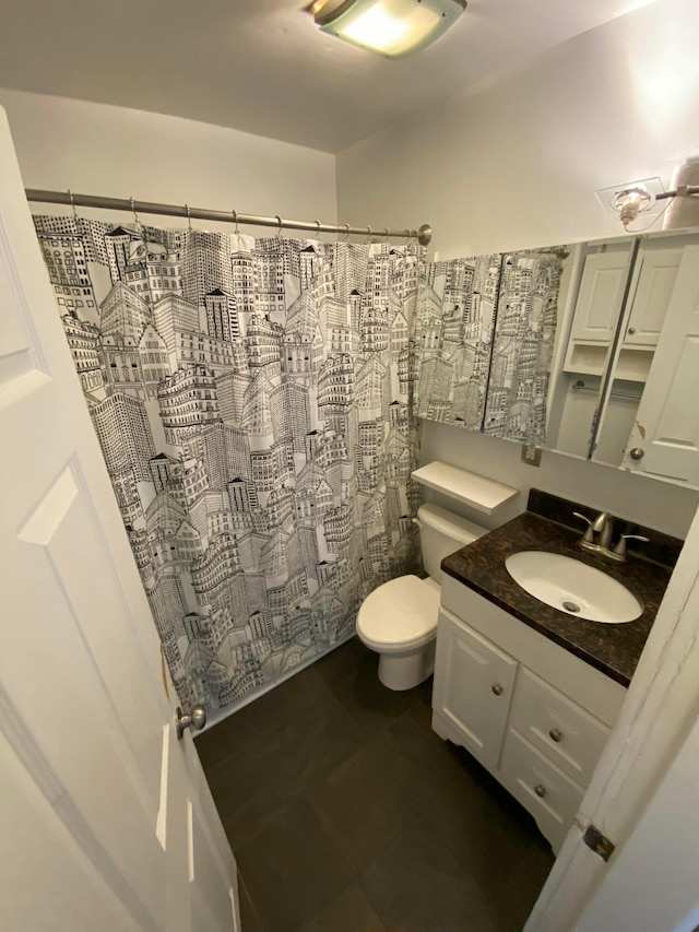 bathroom with vanity, toilet, and walk in shower