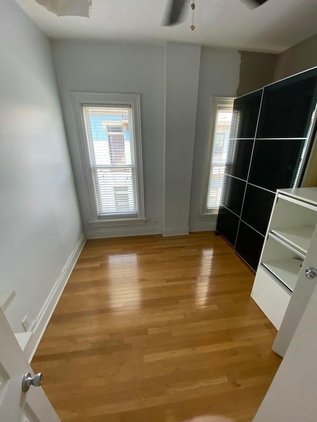 unfurnished room featuring ceiling fan and light wood-type flooring