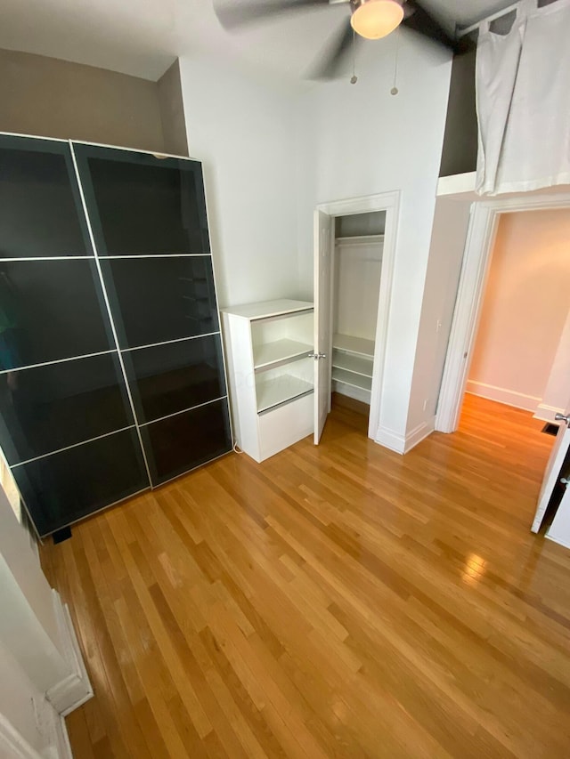 unfurnished bedroom featuring ceiling fan and hardwood / wood-style flooring