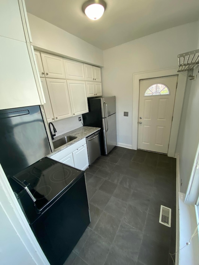 kitchen featuring white cabinetry, sink, and appliances with stainless steel finishes