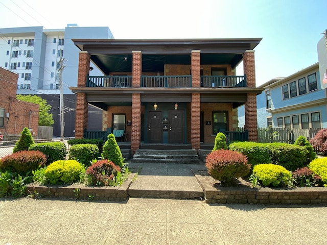 view of front of property with covered porch and a balcony