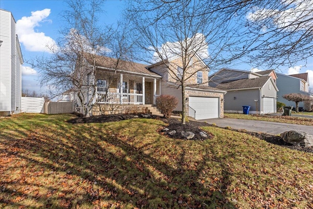 view of front of home with a garage, covered porch, and a front yard