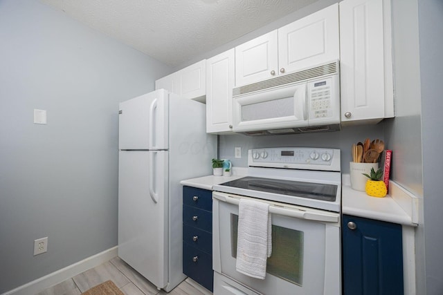 kitchen featuring a textured ceiling, white appliances, white cabinetry, and blue cabinets