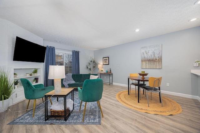 living room with hardwood / wood-style floors and a textured ceiling