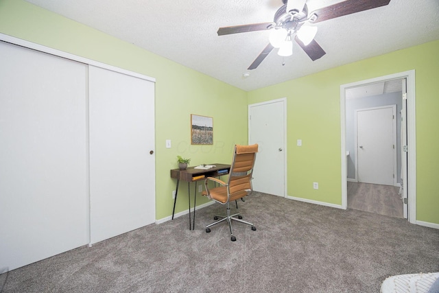 home office featuring carpet, a textured ceiling, and ceiling fan