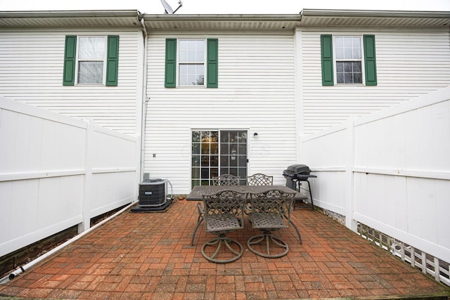 rear view of property featuring a patio and central AC unit