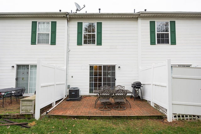 rear view of property featuring cooling unit and a patio