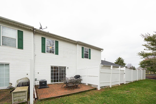 back of house featuring a patio, cooling unit, and a lawn