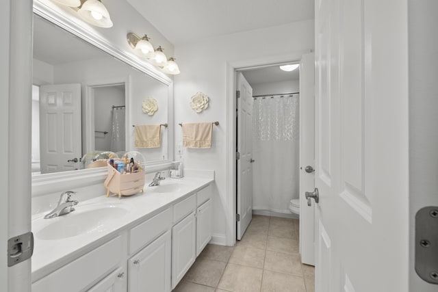 bathroom featuring tile patterned flooring, vanity, and toilet