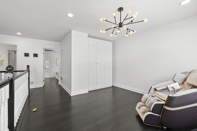 living area featuring dark hardwood / wood-style flooring and a notable chandelier