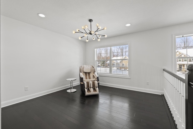 unfurnished room with a notable chandelier and dark wood-type flooring