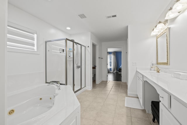 bathroom featuring tile patterned floors, vanity, and shower with separate bathtub