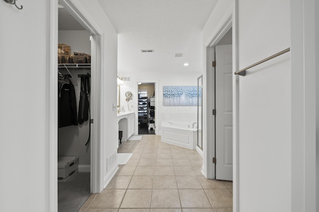 hall with light tile patterned flooring