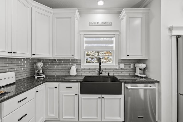 kitchen featuring white cabinets, dishwasher, backsplash, and sink