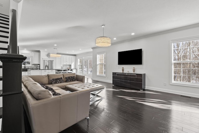 living room with dark hardwood / wood-style floors and ornamental molding