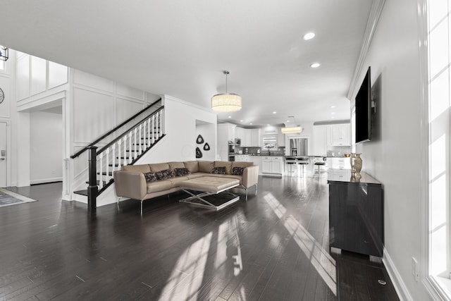 living room with crown molding and dark hardwood / wood-style flooring