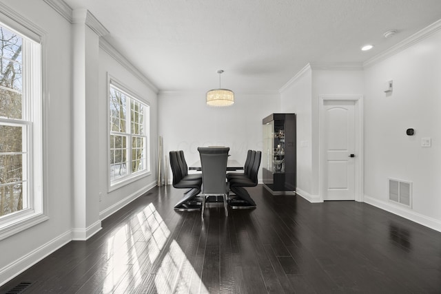 dining room featuring crown molding and dark wood-type flooring