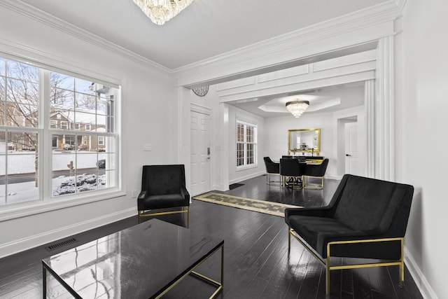 sitting room featuring a notable chandelier, dark hardwood / wood-style floors, and ornamental molding