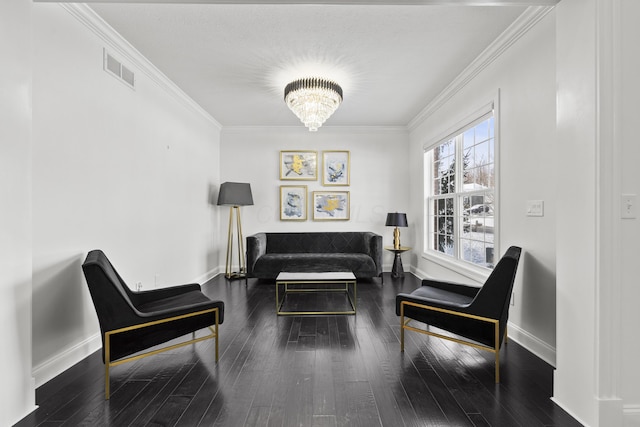 sitting room featuring crown molding, dark hardwood / wood-style floors, and a notable chandelier