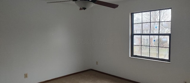 carpeted empty room featuring ceiling fan