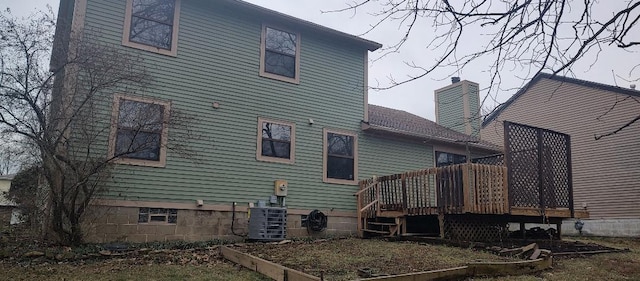 back of house featuring a wooden deck and cooling unit