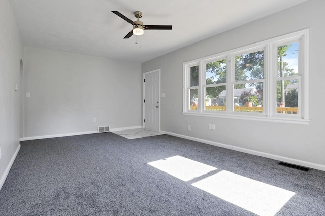 carpeted empty room featuring ceiling fan