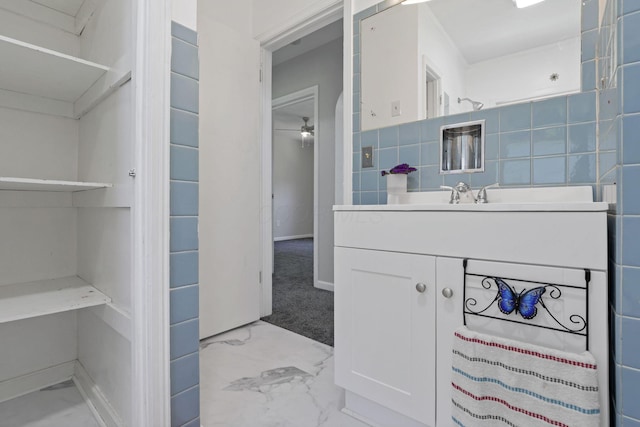 bathroom with decorative backsplash, ceiling fan, and vanity