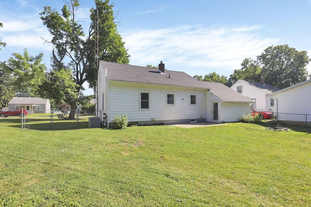 back of house with a yard, a patio, and central air condition unit