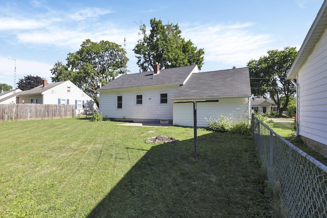 back of property featuring a lawn