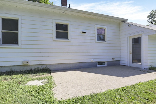 view of side of home featuring a patio area