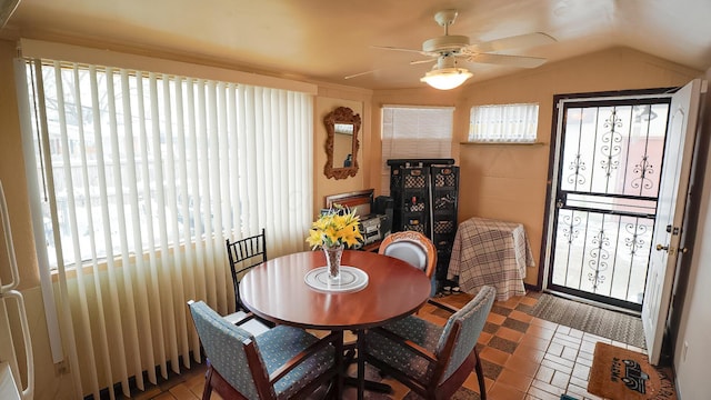 dining space featuring ceiling fan and lofted ceiling