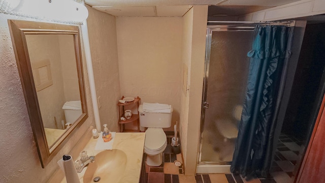 bathroom with sink, an enclosed shower, and toilet