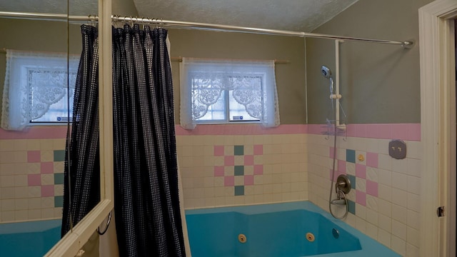 bathroom featuring shower / bath combo with shower curtain and a textured ceiling