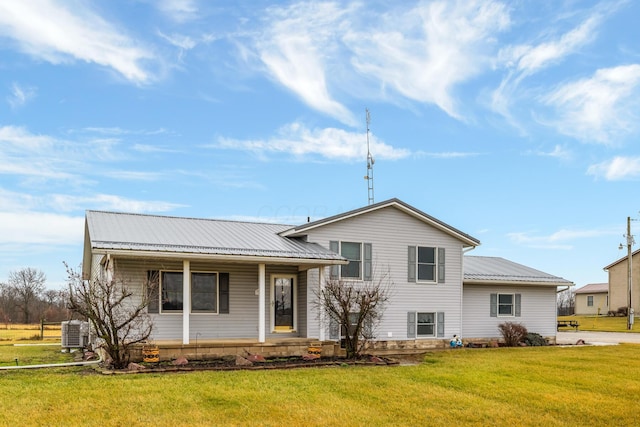 view of front of property with a front yard and central AC unit