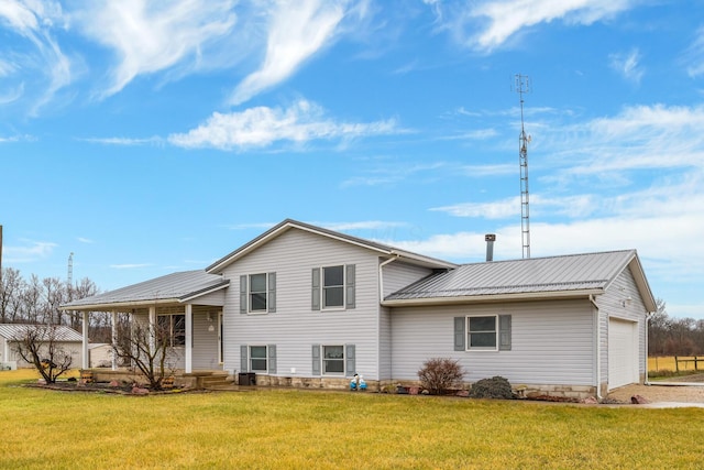 rear view of house featuring a garage, central AC unit, and a lawn