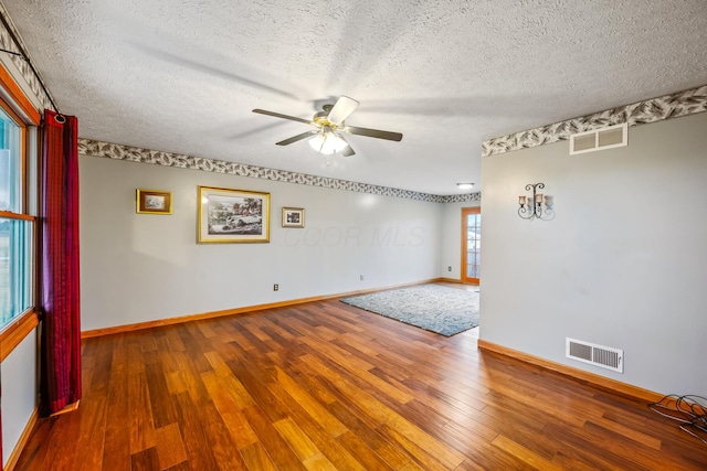 spare room featuring hardwood / wood-style floors, a textured ceiling, and ceiling fan