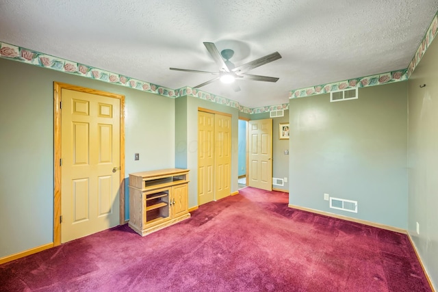 unfurnished bedroom featuring ceiling fan, carpet floors, and a textured ceiling