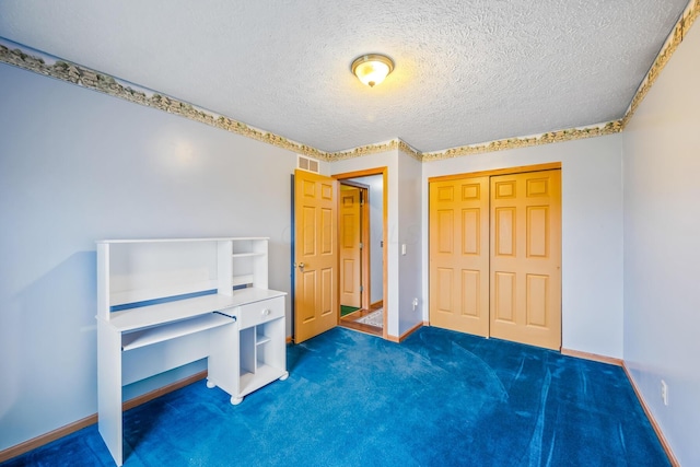 carpeted bedroom with a textured ceiling and a closet