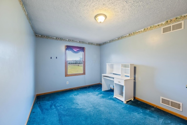 unfurnished office with dark colored carpet and a textured ceiling