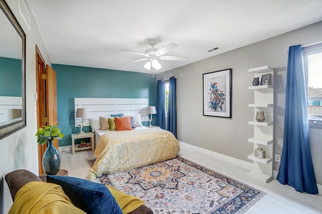 bedroom with ceiling fan and light hardwood / wood-style floors