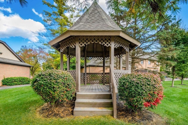 wooden deck with a gazebo and a lawn