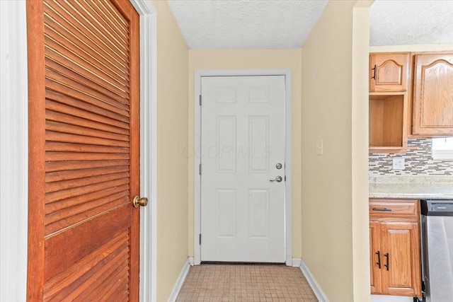 entryway with a textured ceiling