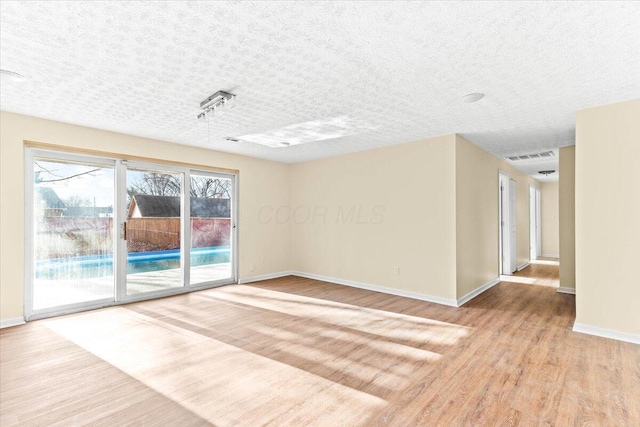 unfurnished room with light hardwood / wood-style floors