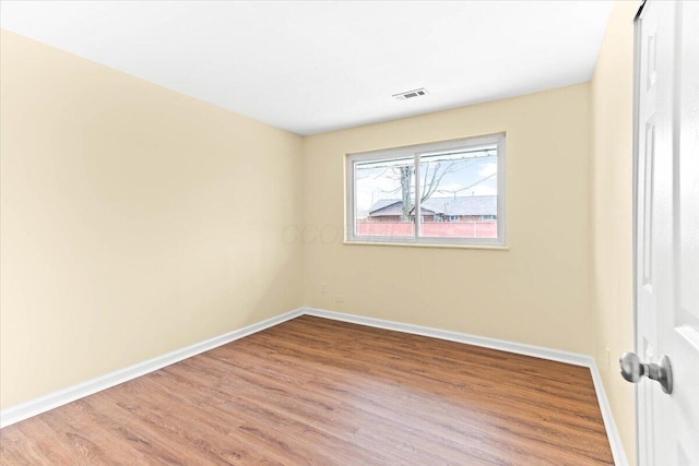 spare room with hardwood / wood-style flooring