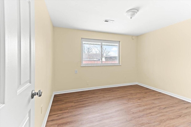 spare room with hardwood / wood-style floors